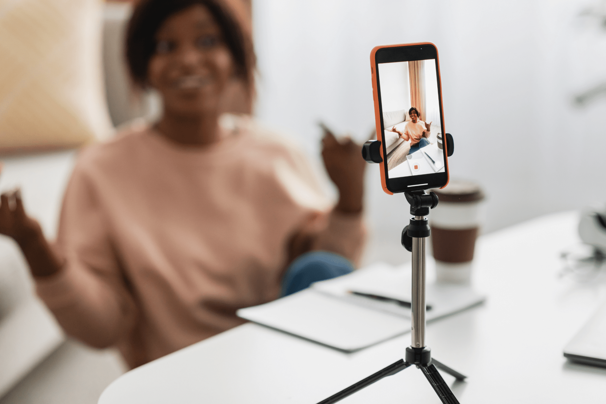 Person using their phone on a tripod to record a video