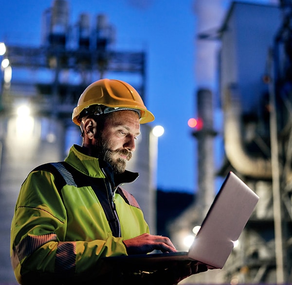 B2B industrial worker using laptop on jobsite