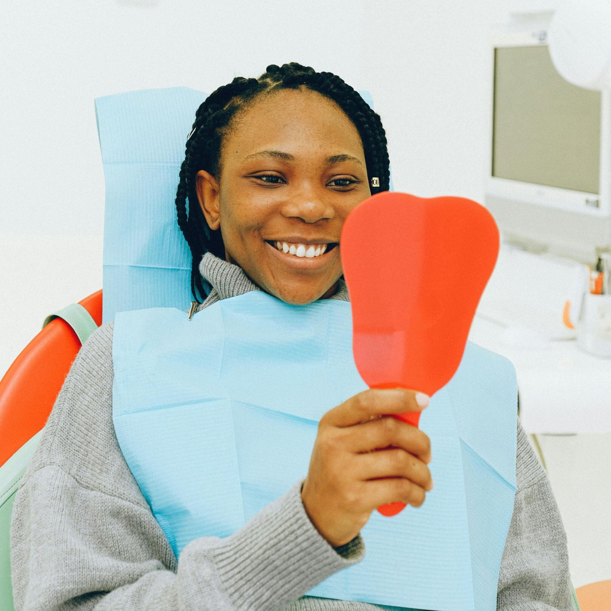 dental patient looking in a mirror dental patient looking in a mirror