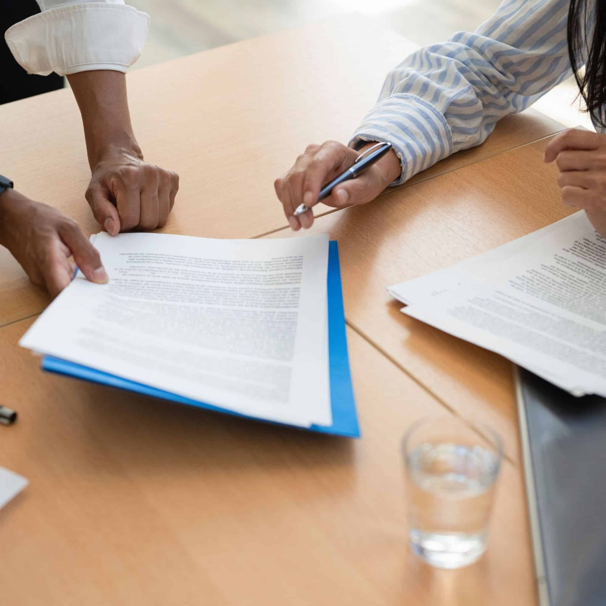 people reviewing legal documents people reviewing legal documents