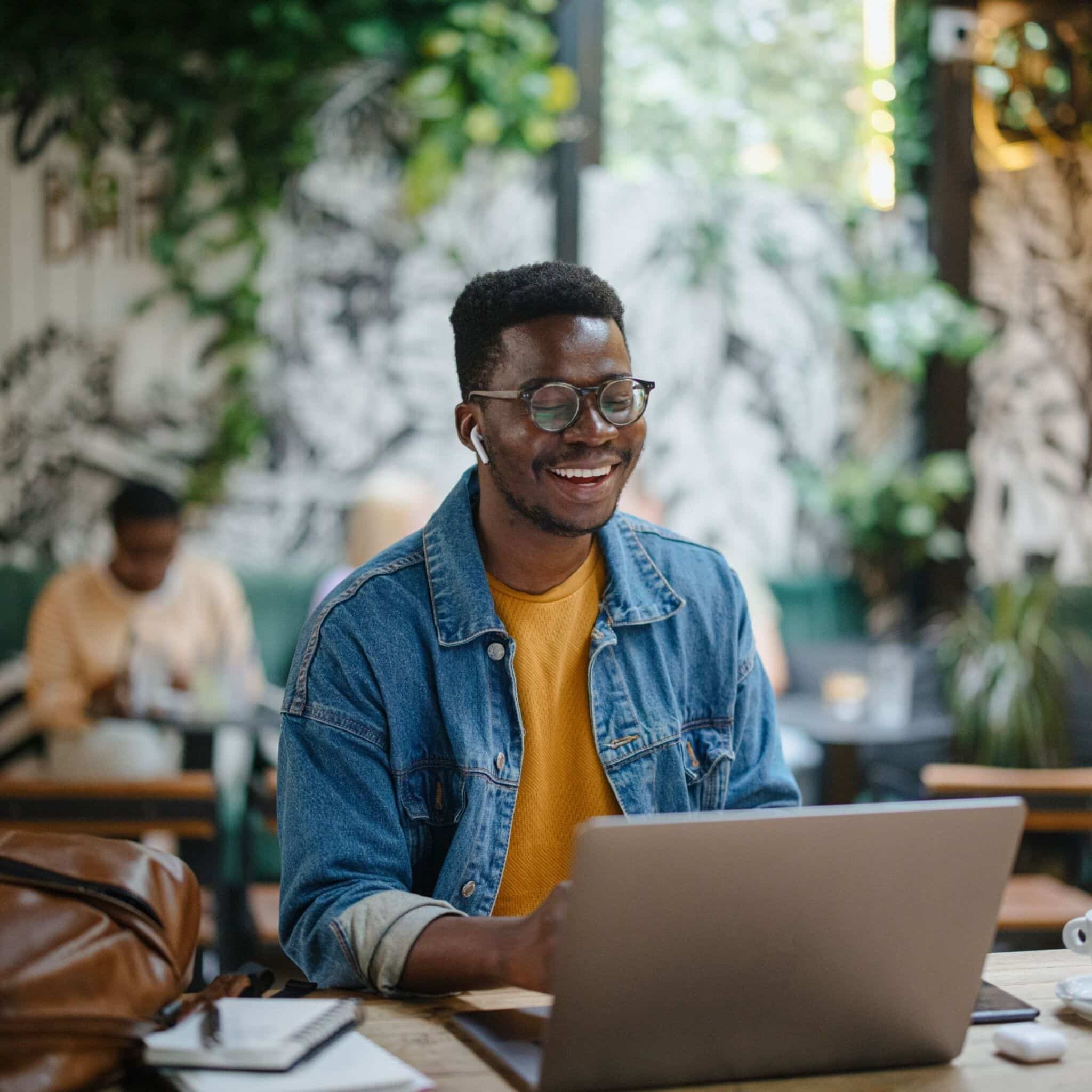 person using laptop at a cafe