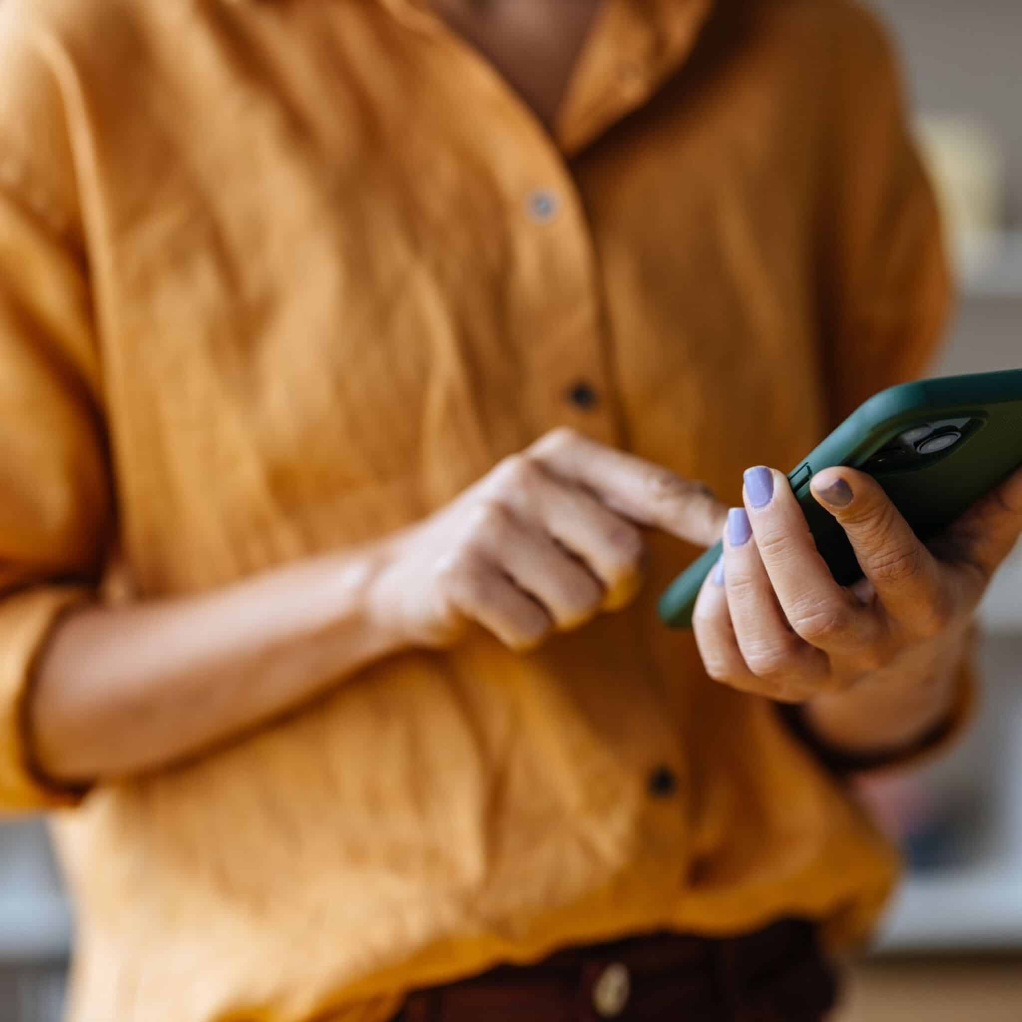 person using their cell phone person using their cell phone
